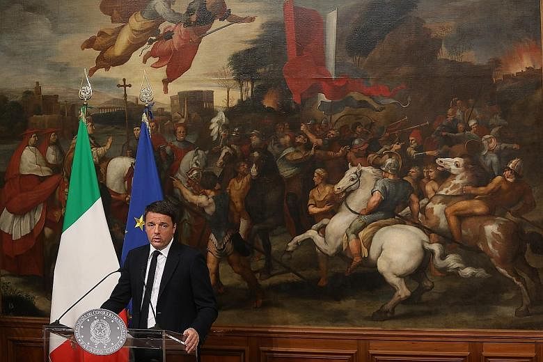 Italian Prime Minister Matteo Renzi at a news conference in Rome yesterday, after acknowledging a crushing defeat over his constitutional reform bid.