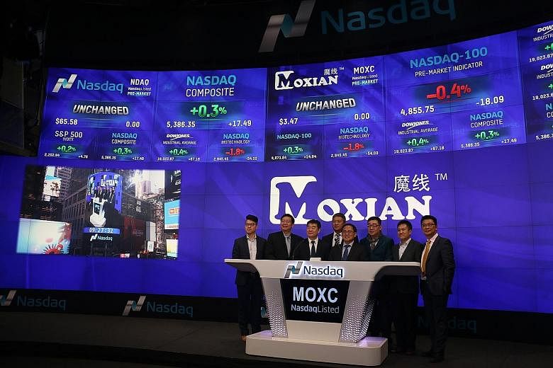 Moxian chief executive James Tan (fifth from left) in New York for the tech company's Nasdaq listing ceremony.