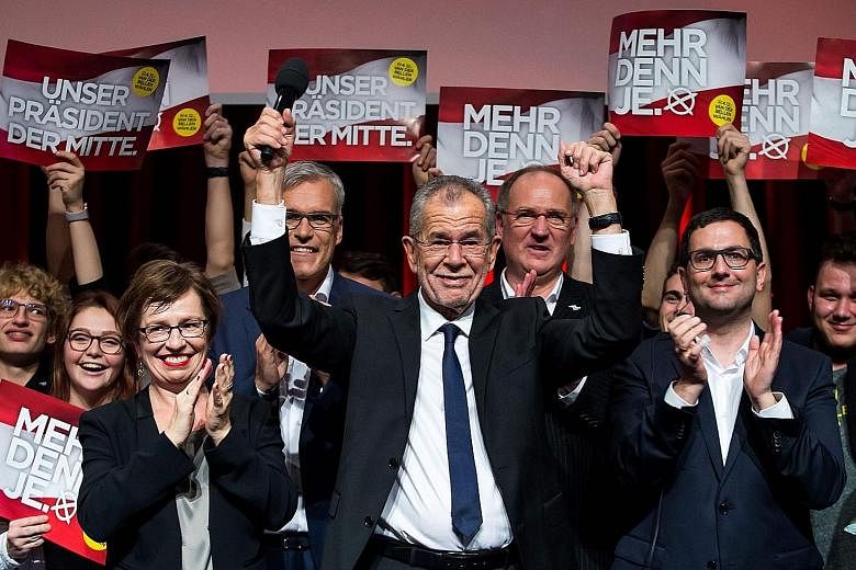 Austrian presidential candidate Alexander Van der Bellen (centre) celebrating his victory over his far-right rival with his supporters at a post-election event in Vienna on Sunday.