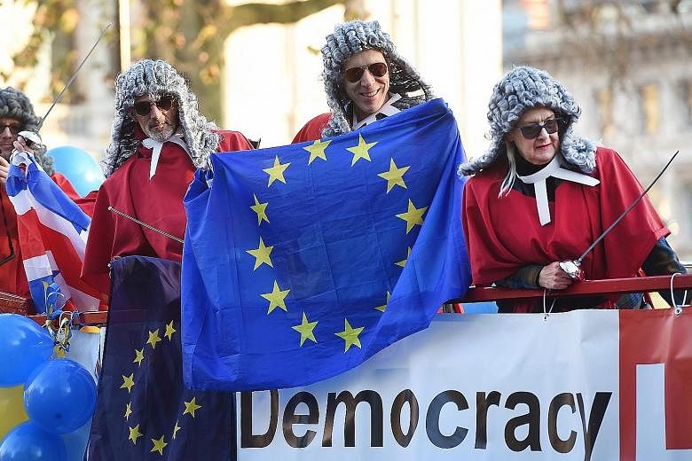 Pro-EU demonstrators dressed as Supreme Court judges outside the Supreme Court yesterday. The court is to decide whether the government can trigger the formal divorce process from the European Union without Parliament's approval.