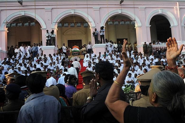 Mourners at the Rajaji Hall in the state capital Chennai yesterday, where Ms Jayalalithaa's body was lying in state before the casket was taken in a funeral procession to her final resting place at Marina Beach.