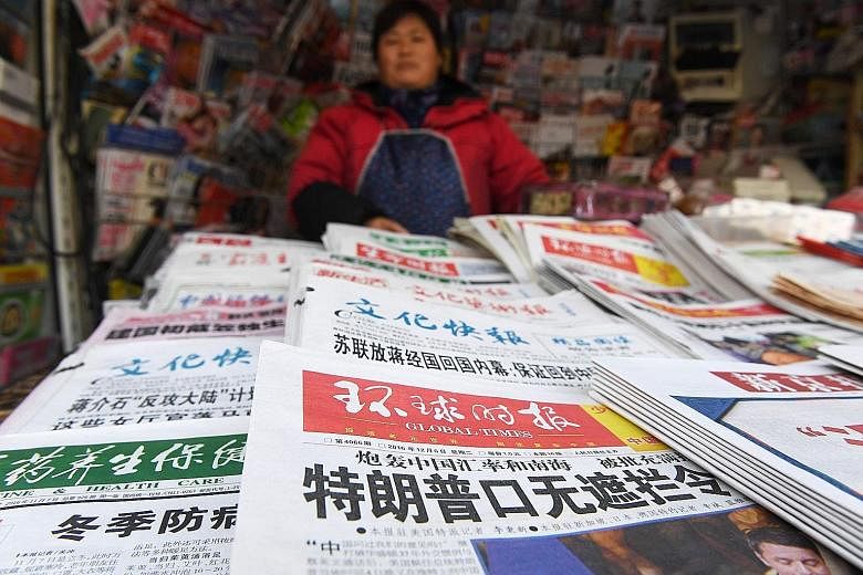 Newspapers at a news kiosk in Beijing yesterday, including one in the foreground with a front-page article on US President-elect Donald Trump. The headline reads: "Trump's inability to keep his mouth shut is stunning."