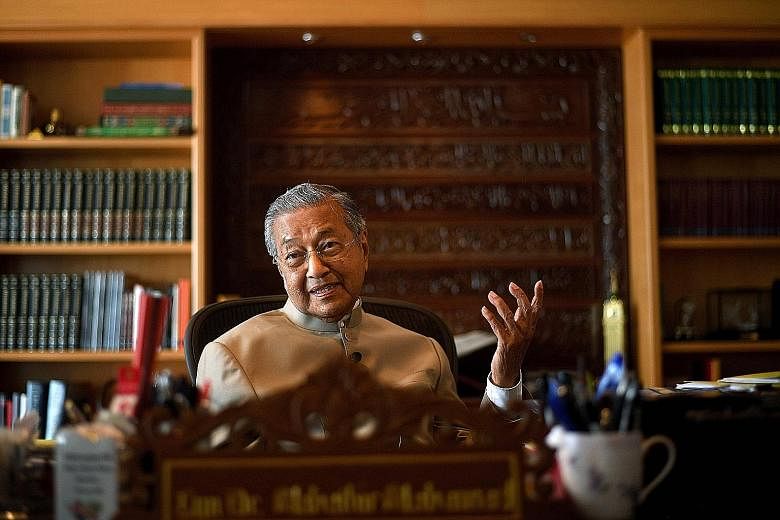 Dr Mahathir, seen here in his office in Putrajaya, says he has made overthrowing the current Malaysian PM a top priority, and is willing to set aside personal feelings to work with other opposition parties.