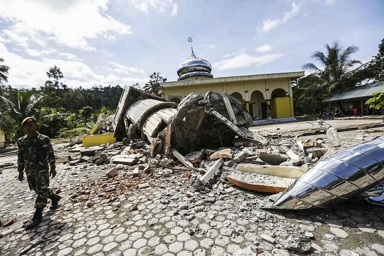 A mosque in ruins after the quake struck Pidie Jaya, in Aceh province, yesterday. About 280 buildings collapsed, prompting many to question why more was not done to reinforce buildings in the area.