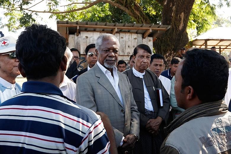 Former UN secretary- general Kofi Annan and commissioner Aye Lwin of the multi-sector advisory commission meeting members of the Muslim community in Kyatyoepyin village in Rakhine state.
