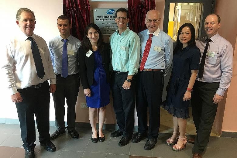 (From left) Dr Liam Tully, director of Pfizer's API technology team; Dr David Walker, team leader of Pfizer's MTDC; Ms Ho Weng Si, EDB director of biomedical sciences; Mr George Routhier, managing director and site leader of Pfizer Asia Pacific; Dr K