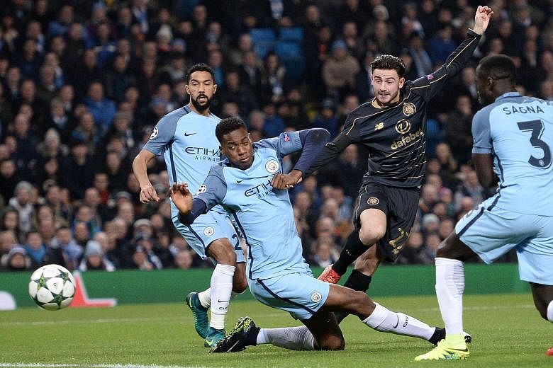 Celtic midfielder Patrick Roberts shoots past Manchester City defender Oluwatosin Adarabioyo (centre) to score the opener in the Champions League group game. 