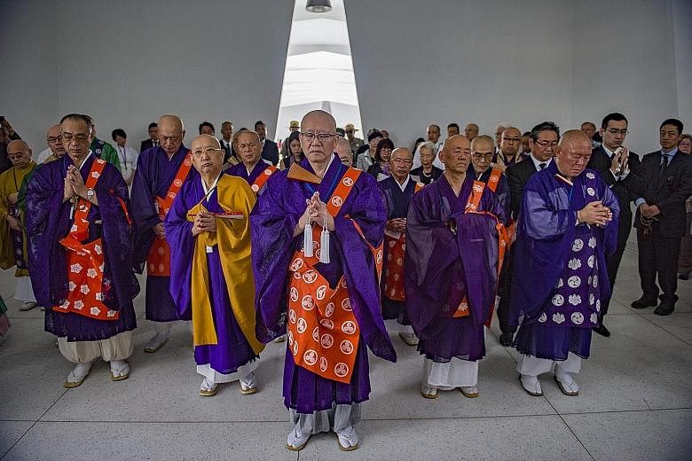 Religious leaders praying during an interfaith service at the USS Arizona Memorial in Honolulu, Hawaii, on Tuesday to commemorate the 75th anniversary of the attacks on Pearl Harbor and Oahu. Religious leaders from the United States military, Hawaii 