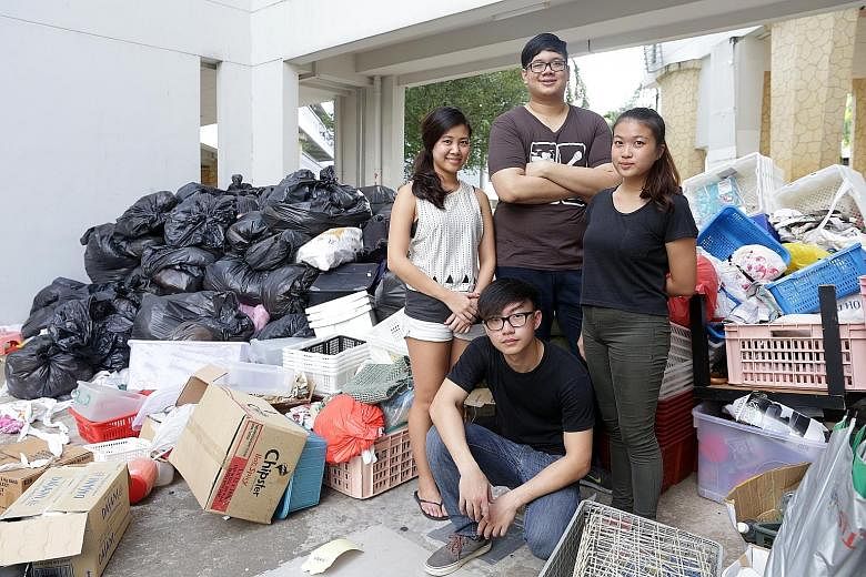 Clockwise from right: Core team members of Silver Ribbon's youth chapter Trini Low, 21, and Jonathan Kuek, 26, with volunteers Keren Lee, 25, and Gerald Tan, 21. Around them is a portion of the clutter that 25 young volunteers removed from the flat o