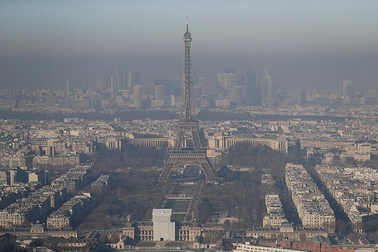 Paris' famous Eiffel Tower shrouded in a greyish haze, as the French capital experienced the worst air pollution in a decade due to a lack of winds. The city has implemented a ban on cars for the third consecutive day, based on whether their licence 