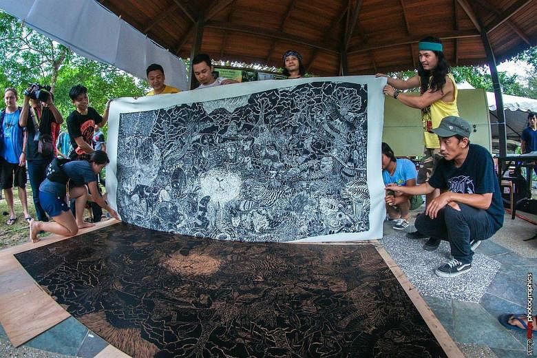 Highy intricate and evocative woodcut prints being displayed at an event organised by Pangrok Sulap, a Sabah-based collective of artists, musicians and social activists who hope to empower rural communities through art.