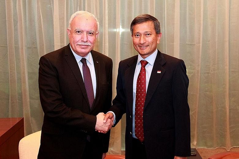 Dr Vivian Balakrishnan (right) meeting the Palestinian National Authority's Minister of Foreign Affairs, Dr Riyad Al-Maliki, who was in transit in Singapore yesterday.