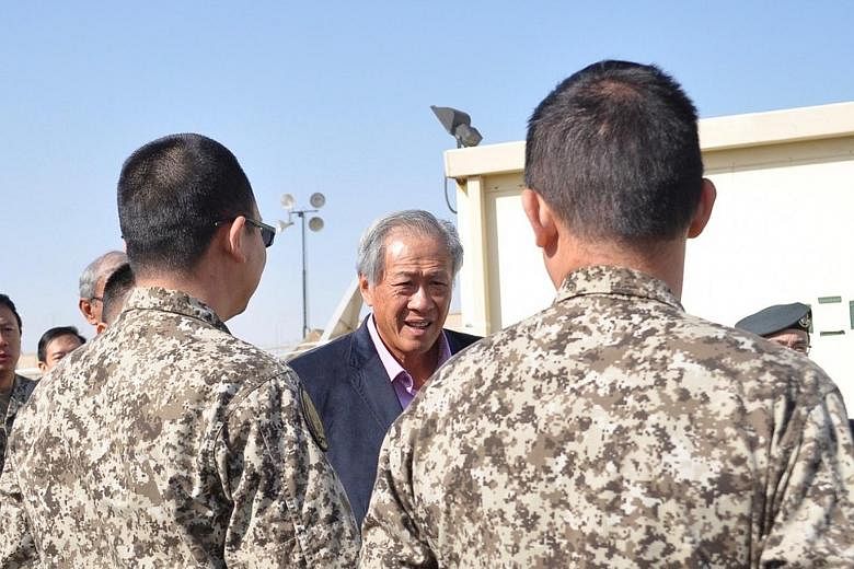 Defence Minister Ng Eng Hen with members of the SAF's Imagery Analysis Team that has been supporting the counter-ISIS coalition at the Combined Joint Task Force Headquarters in Kuwait.