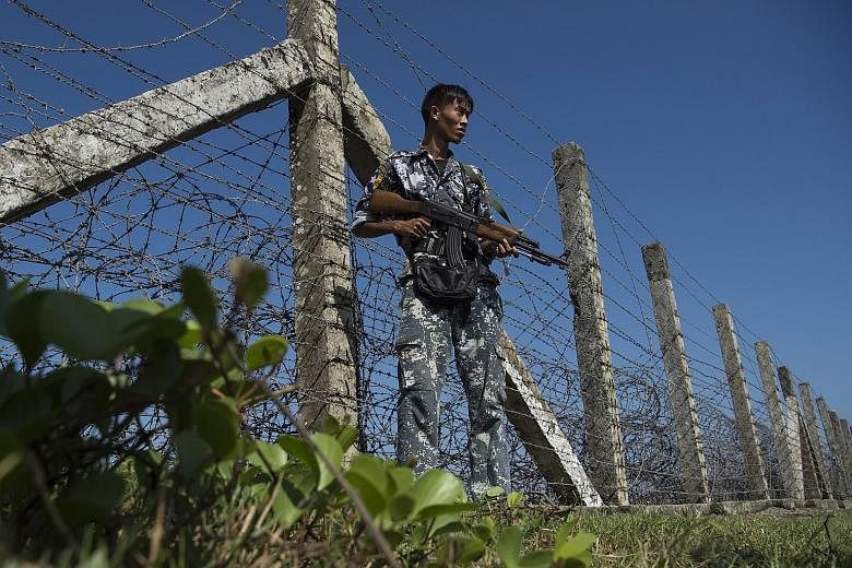 A Myanmar policeman standing guard near the border with Bangladesh in Rakhine, where the Myanmar army is accused of carrying out a brutal crackdown on the Rohingya minority.