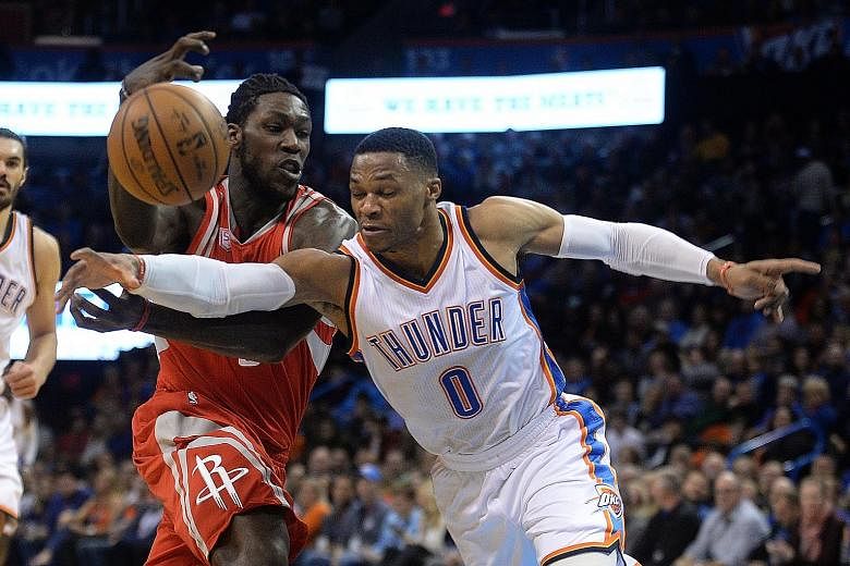 Oklahoma City Thunder guard Russell Westbrook attempting a steal from Houston Rockets forward Montrezl Harrell during Houston's 102-99 win on Friday.