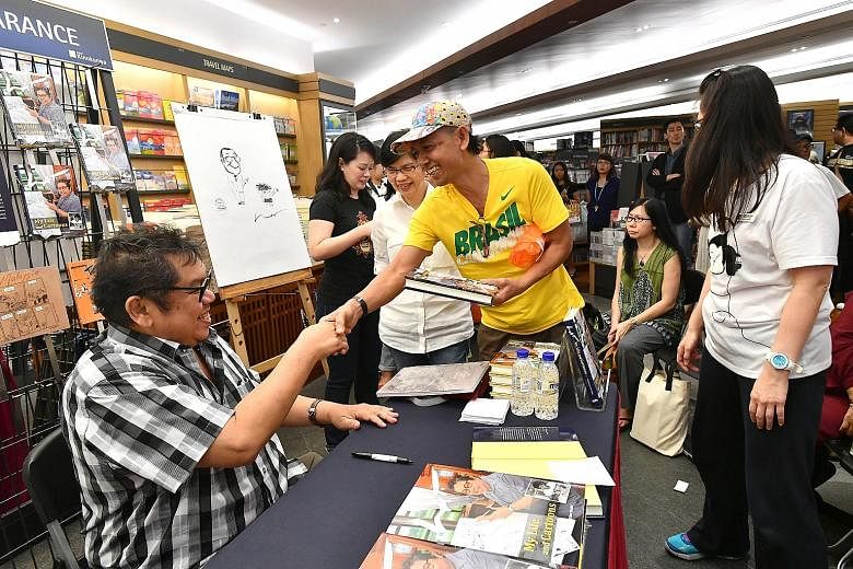 Above: Material handler Rahman Amat, 59, (in yellow shirt) was one of the first few to get an autograph from Lat at the cartoonist's launch of Lat: My Life And Cartoons at Books Kinokuniya in Ngee Ann City yesterday. Below: Lat treated the crowd to a