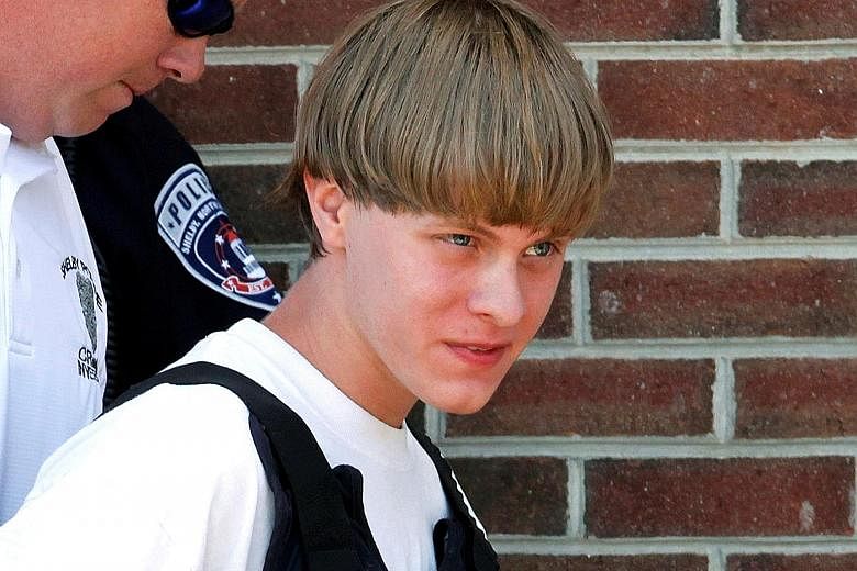 Police leading gunman Dylann Roof into court in Shelby, North Carolina, a day after the shooting. Roof is on trial for killing nine African Americans in a South Carolina church on June 17 last year.