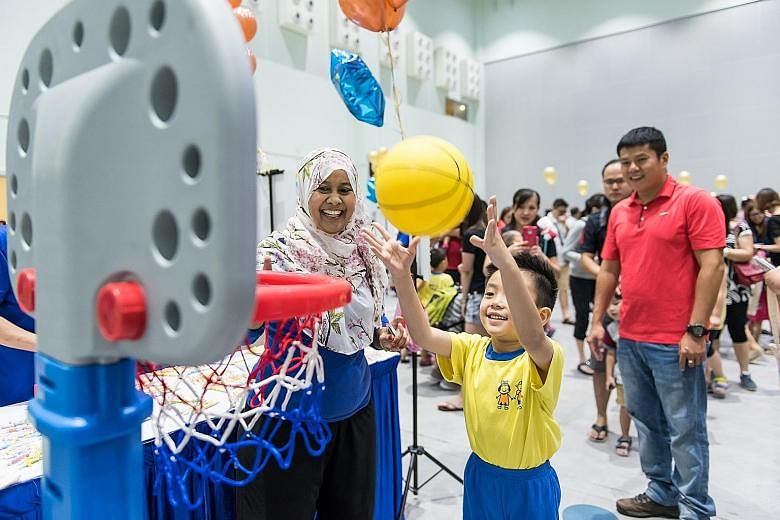 A Star Learners' childcare centre pupil playing at the centre's charity fun fair in July. The event raised $15,000 for The Straits Times School Pocket Money Fund.