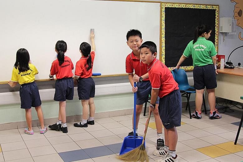 Left:Teck Ghee Primary School pupils cleaning their classroom earlier this year. Below: Beatty Secondary School students cleaning their classroom as part of their school's morning routine. In February, MOE announced that it would make daily cleaning 