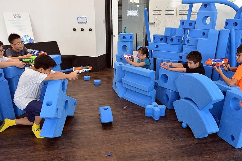 Kids enjoy a Nerf gun shootout at indoor playground Kaboodle Kids, which aims to stimulate creativity in kids and engage their senses, among other things.