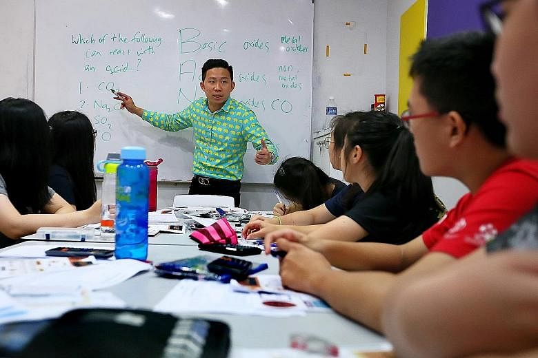 Bright Culture founder Joel Liu during a chemistry session with secondary students. He said the holiday period is crucial for those taking major exams next year.