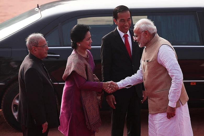 ceremonial reception for the Indonesian President at the forecourt of the Rashtrapati Bhavan, or presidential palace, in New Delhi yesterday. Beside them is Indian President Pranab Mukherjee.