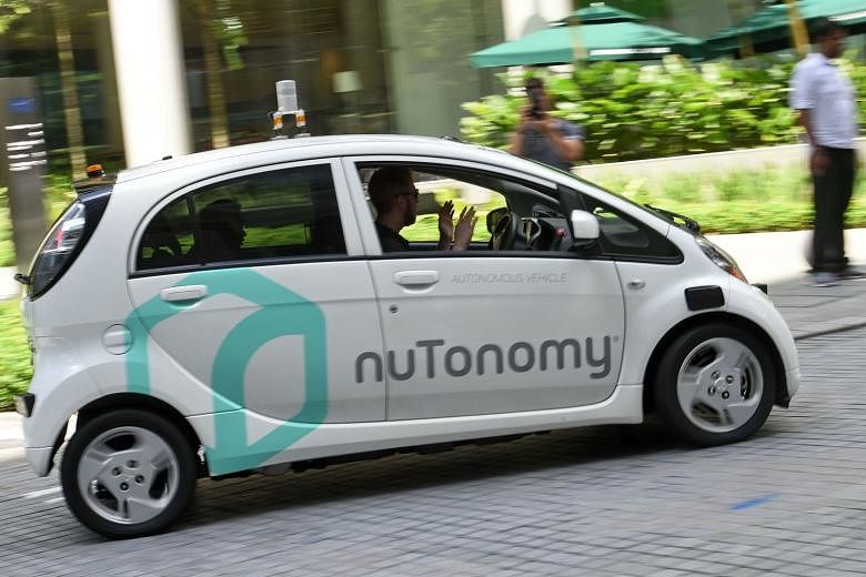 A safety driver demonstrating a driverless car during a public trial run here in September. The question of who is to blame in an accident involving an autonomous vehicle remains a sticking point here.