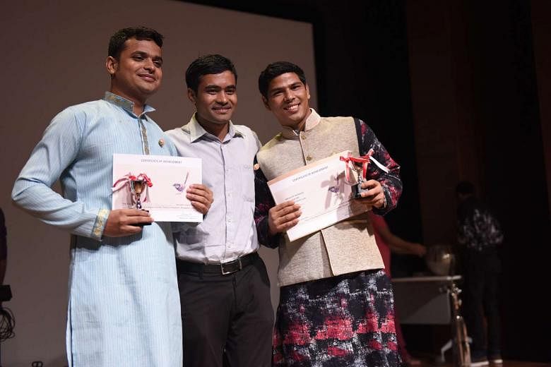 Bangladeshi Bikas Nath (left) won first prize at this year’s Migrant Worker Poetry Competition while his friend, Mr Md Mukul Hossine (right), tied for third place with a domestic worker from the Philippines. With them is their compatriot and a previous wi
