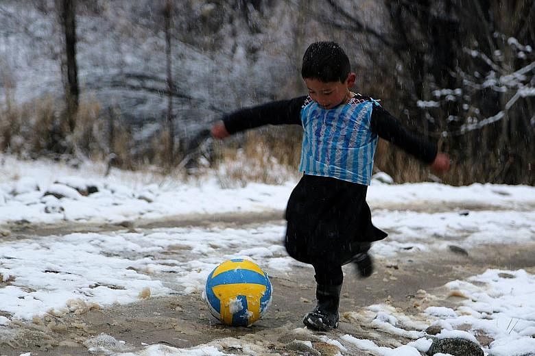 More than 10 months after Murtaza Ahmadi became an Internet sensation when pictures of him wearing an improvised Lionel Messi football shirt made from a plastic bag (above) went viral, the six-year-old Afghan boy finally got to meet his idol. Murtaza