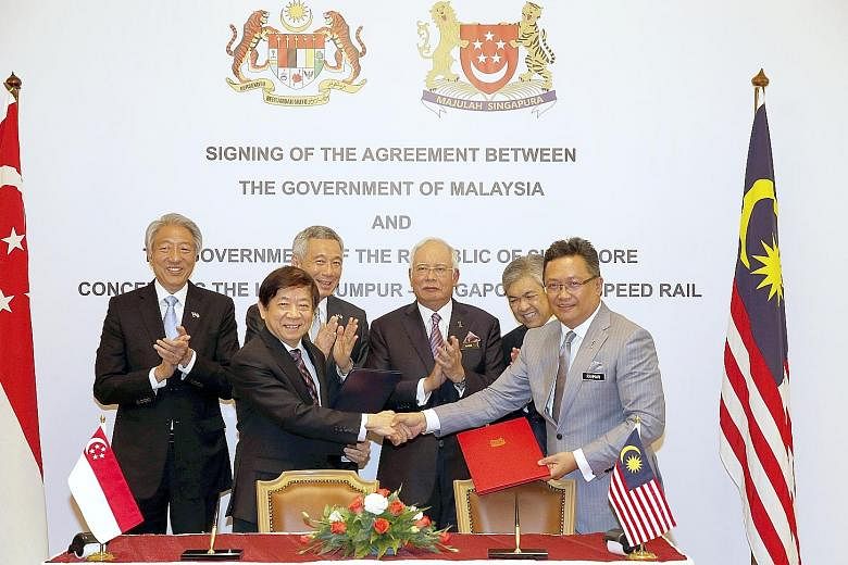 PM Lee and Mr Najib, flanked by their deputy prime ministers Teo Chee Hean (left) and Ahmad Zahid Hamidi, witnessed the signing of the HSR pact yesterday by Singapore's Coordinating Minister for Infrastructure and Minister for Transport Khaw Boon Wan