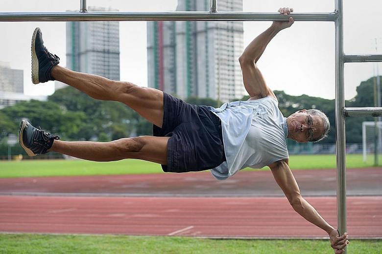 Mr Ngai Hin Kwok, 67, demonstrating his strength and fitness with the "human flag" pose at Toa Payoh Stadium. A member of Team Strong Silver - comprising seven fitness enthusiasts with an average age of 68 - the grandfather of three has worked out re