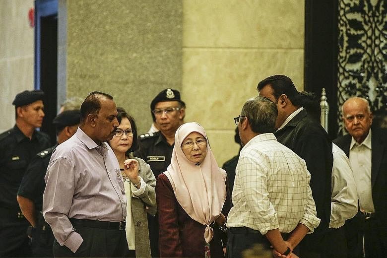Anwar's wife Wan Azizah (at centre) with supporters after he lost his final appeal against his conviction and five-year jail term yesterday.