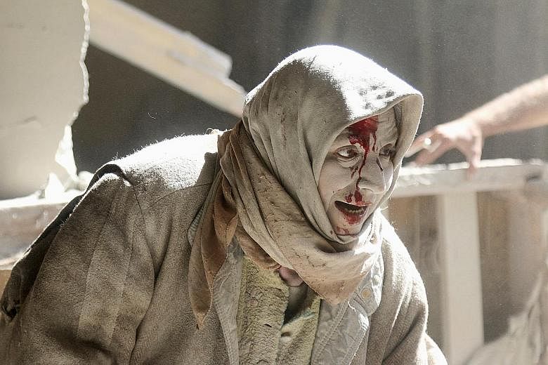 An injured woman at a site hit by air strikes in the rebel-held area of Old Aleppo in April this year. The bloodshed could now intensify, diplomats fear.