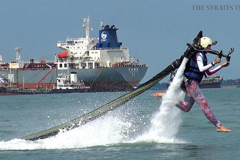 Journalist Bridget Tan piloting a 12kg jetpack, which can boost its rider up to 9m above the water.