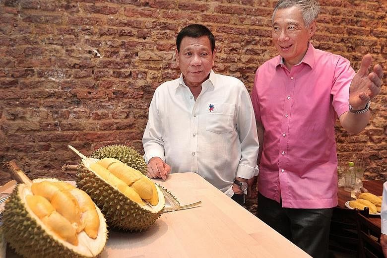 PM Lee with Mr Duterte at lunch yesterday. Noting it was the second time this week he was having durians, Mr Lee said: "International diplomacy is indeed dangerous for waistlines!"