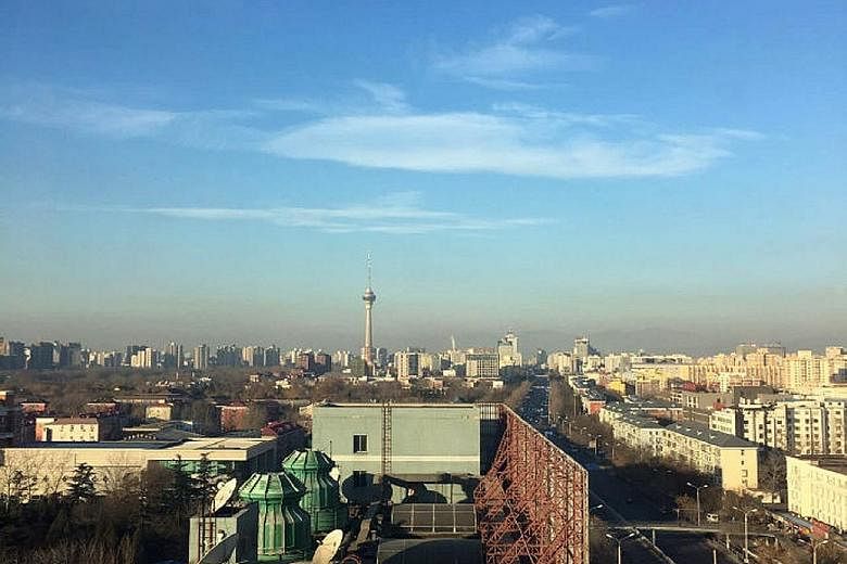 The view from a building in Beijing at 8.40am yesterday (left) versus the same spot at 3pm (right). Severely high levels of smog are forecast to cover parts of northern China for five days.