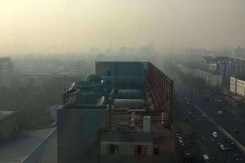 The view from a building in Beijing at 8.40am yesterday (left) versus the same spot at 3pm (right). Severely high levels of smog are forecast to cover parts of northern China for five days.
