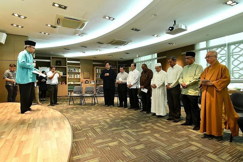 Leaders of religious groups representing multiple faiths observing a minute of silence at the Harmony Centre in Bishan yesterday. They were doing this for victims of the violence in Myanmar's Rakhine State and the earthquake that struck Aceh in Indon