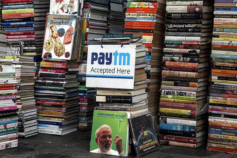 A book store in Mumbai lets customers know that it accepts payment via Paytm. The government will give away prizes worth from 1,000 to 10 million rupees to merchants and consumers who choose such digital payment methods.