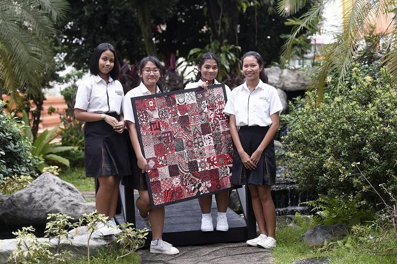 Northland Sec student leaders (from left) Dania Nur Insyirah, 15, Bridget Tong, 14, Nur Qistina Muhd Rizhal, 14, and Chua Vina, 14, pose with an art piece created by staff and students from Northland and North View, which have merged.