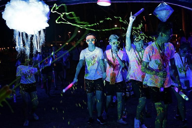 Some 6,000 participants glowing neon on Saturday, adding to the colour at the fourth Illumi Run held at Sentosa's Palawan Green. Participants were doused in glow-in-the-dark paint as they ran and danced through the night. One of the highlights was a 