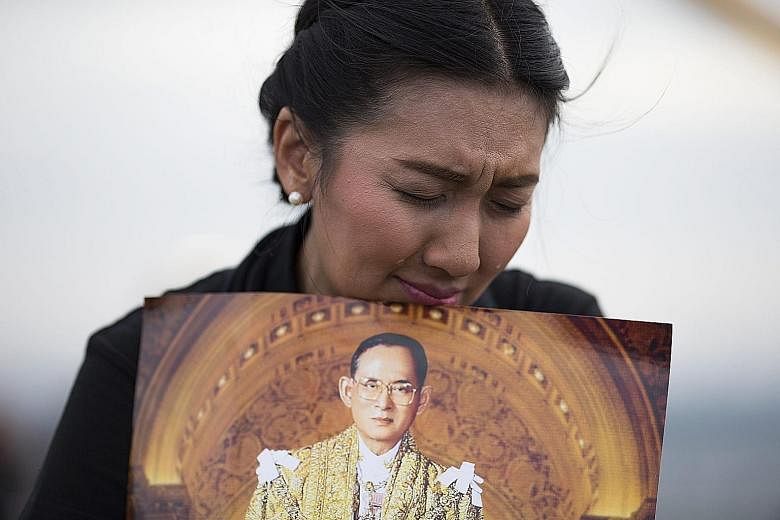 A Thai mourner with a portrait of the late Thai King Bhumibol Adulyadej, who died on Oct 13 at the age of 88.