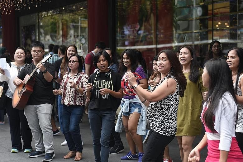 The flash mob, a 15-strong amateur choir of foreign domestic workers, brought Yuletide cheer to Orchard Road.
