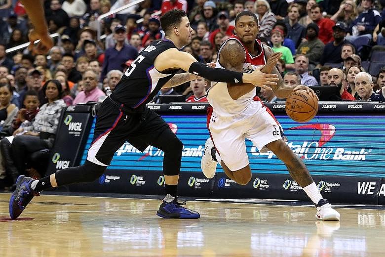 Washington Wizards' Bradley Beal is fouled by Los Angeles Clippers' Austin Rivers while attempting to dribble past him. The Washington guard had his second 40-point game of the season in his team's 117-110 victory.