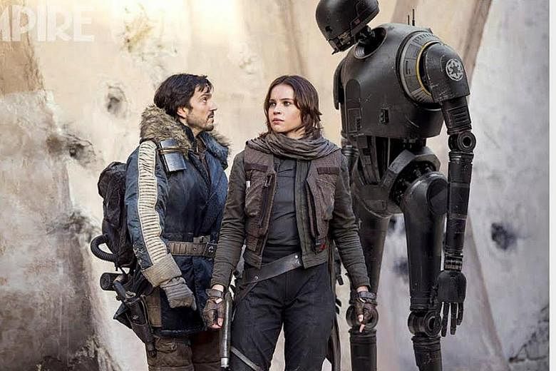 Actor Alan Tudyk plays Rogue One's droid K-2SO (right), seen here with Rebel fighters Cassian Andor (Diego Luna, far left) and Jyn Erso (Felicity Jones).