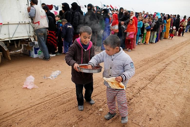 Boys who fled Mosul receiving food at a refugee camp. Up to one million people are trapped inside Mosul, running low on food and drinking water and facing the worsening cruelty of ISIS fighters. Those who fled faced harrowing journeys, and many have 