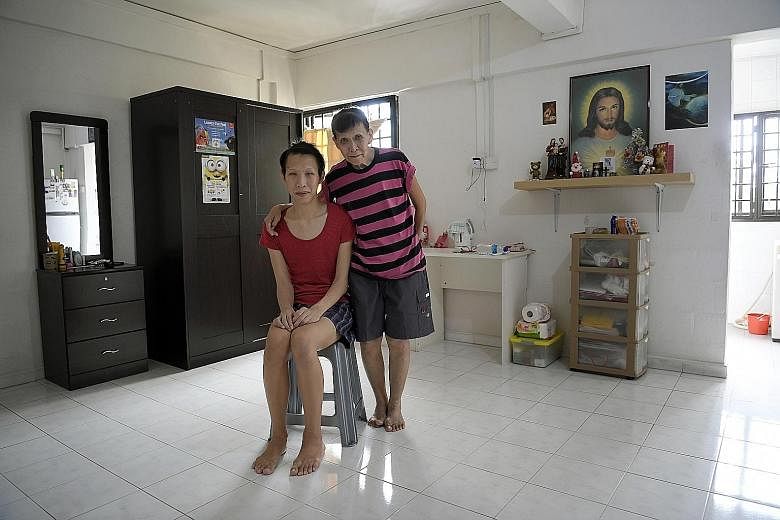 Madam Tan with her son Kevin Ong in their one-room rental flat in Ang Mo Kio. The single mother lost her job earlier this year, mainly because she had to look after her son, who has a blood disorder and an intellectual disability.