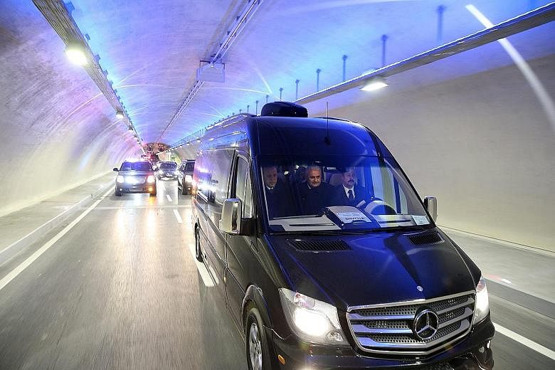 Turkish President Erdogan (left) and Prime Minister Binali Yildirim (centre) crossing the Avrasya (Eurasia) Tunnel in a van yesterday. The tunnel required an investment of $1.8 billion.