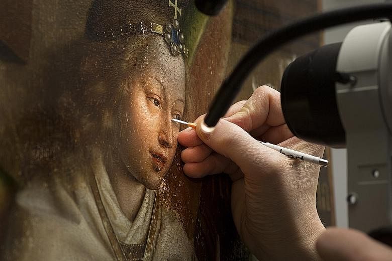 The Ghent Altarpiece (above) is recognised as one of history's most influential artworks because of the intimate attention it gives to both earthly and divine beauty. A scalpel being used (below) to remove overpaint from the image of the Archangel Ga