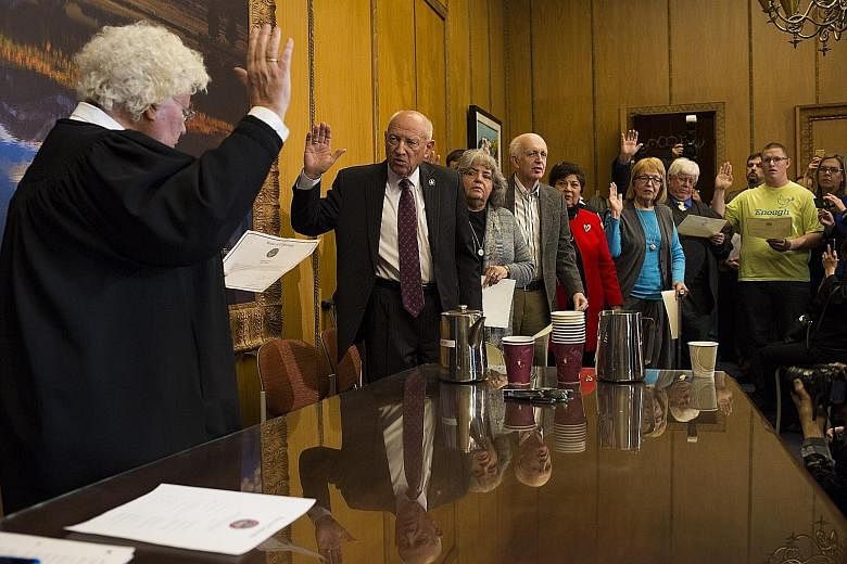 Colorado electors taking an oath before the Electoral College vote at the State Capitol building in Denver on Monday. Mr Trump's detractors called on electors to favour Democrat candidate Hillary Clinton, or Mr Trump's running mate, Mr Mike Pence, or